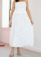 White strapless dress with floral patterns on a plain background