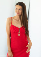 Woman wearing a red dress with a white background