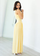 Woman wearing a yellow dress against a white background