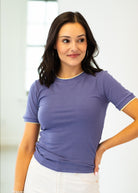 Woman wearing a purple t-shirt against a white background
