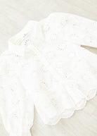 Close-up of a white lace doily on a light background