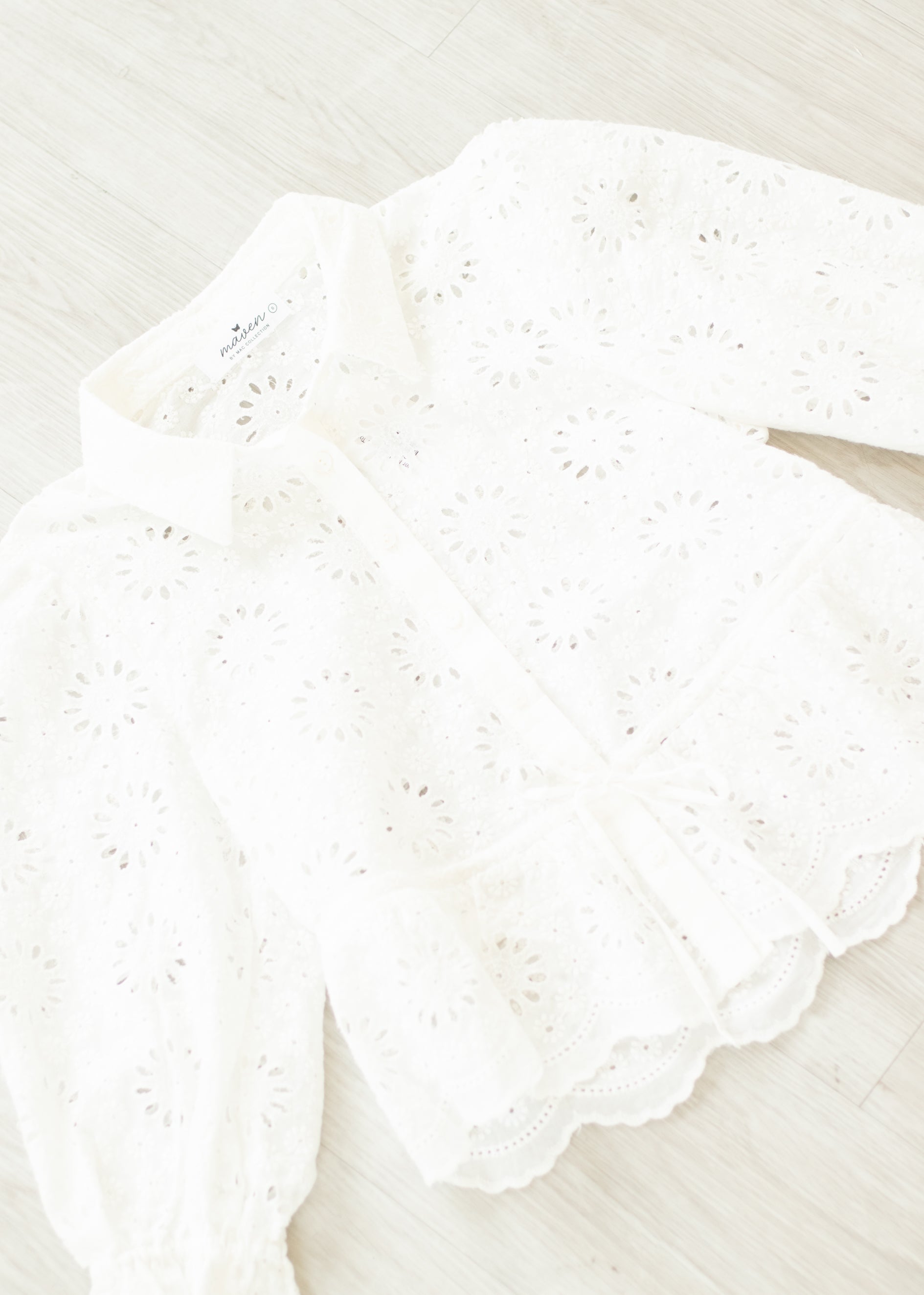 Close-up of a white lace doily on a light background