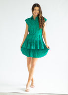 Woman wearing a green dress on a white background