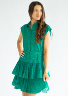 Woman wearing a green polka dot dress on a white background