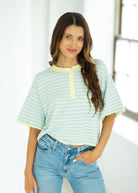 Woman wearing a striped shirt and jeans indoors