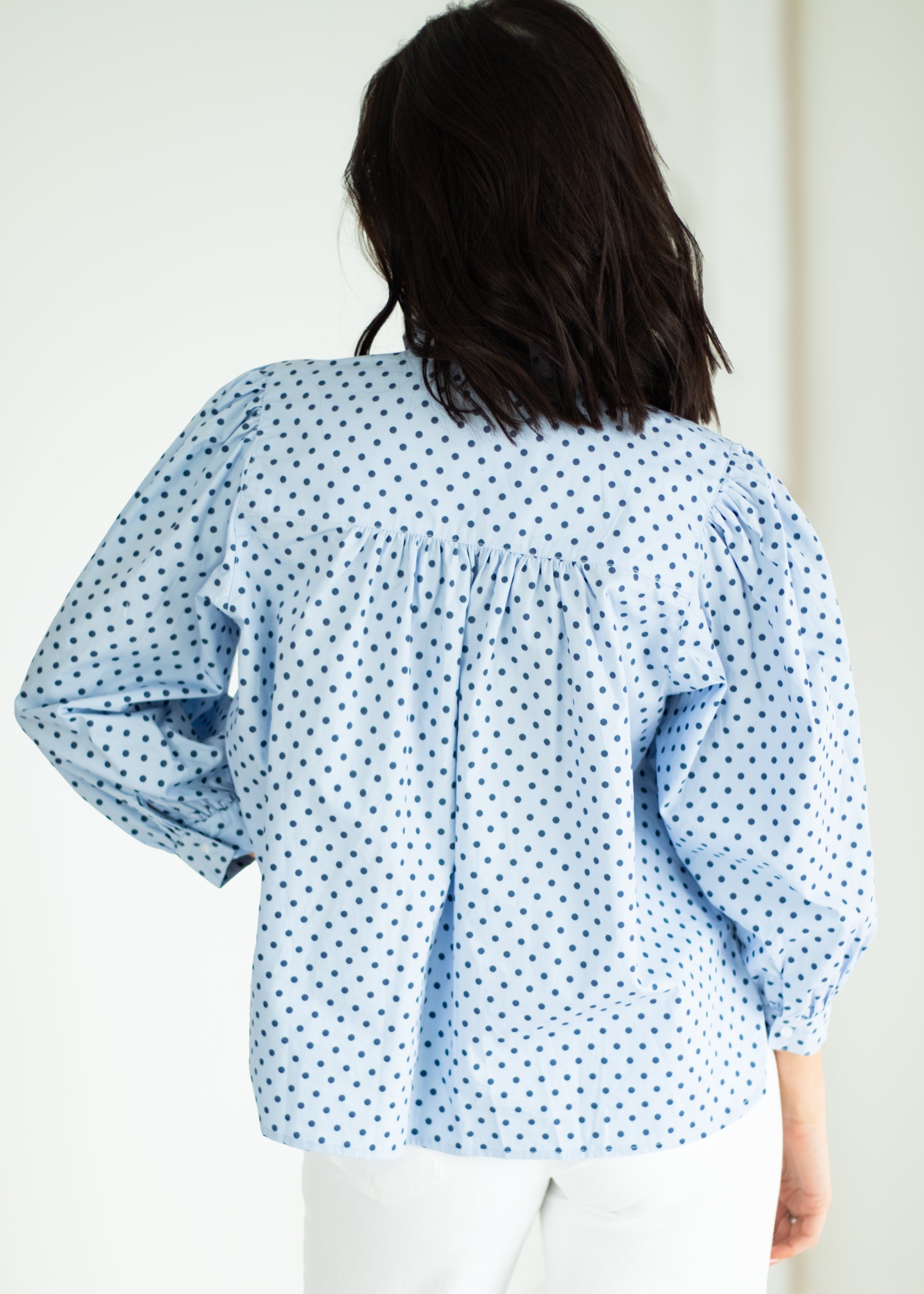 Woman wearing a light blue romper on a white background