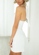 White dress worn by a person with a blurred background