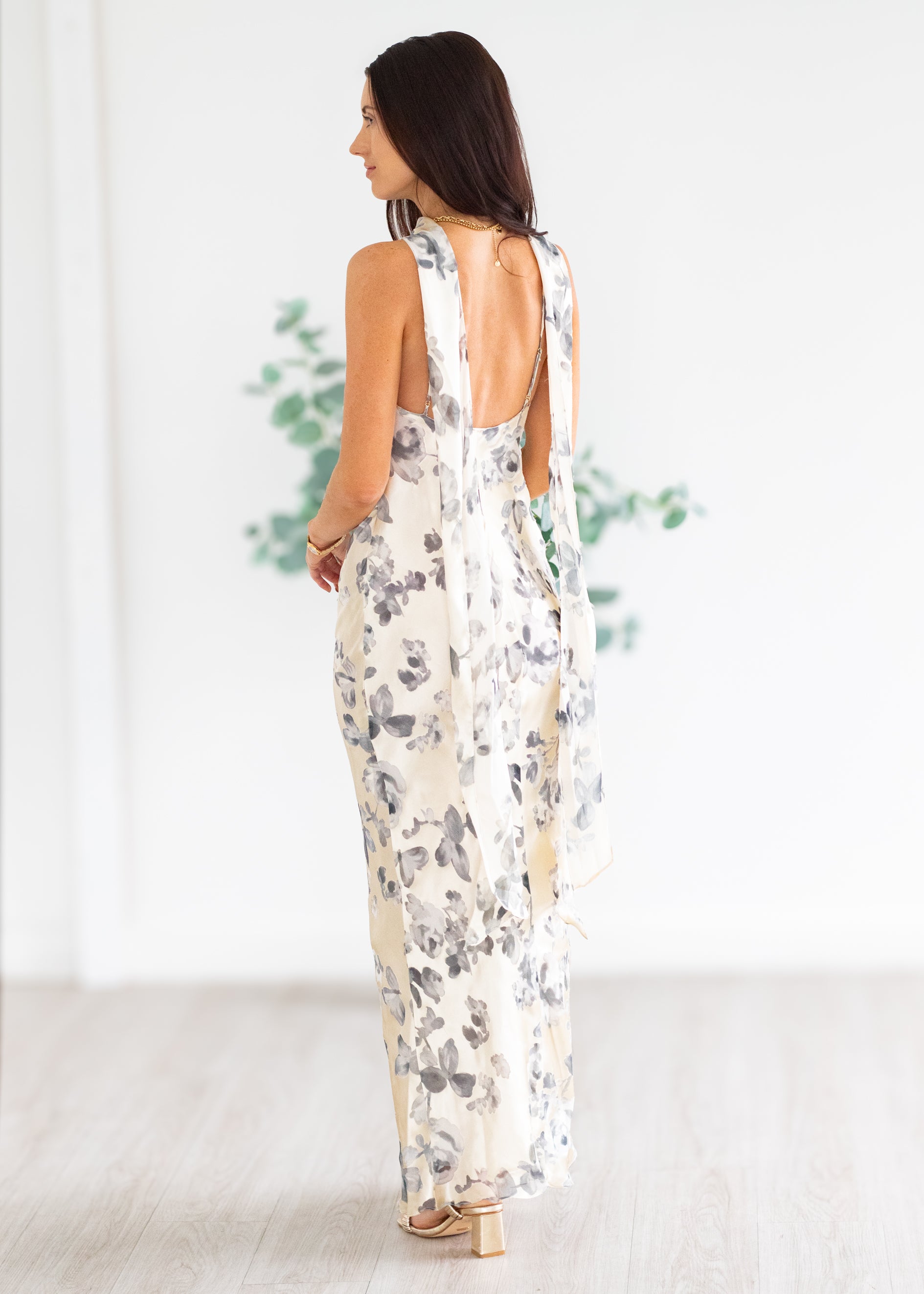 Woman wearing a floral maxi in a minimal indoor setting