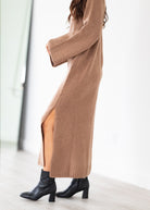 Long brown sweater maxi with a slit on a white background
