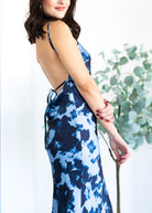 Woman wearing a blue floral dress with a blurred background