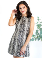 Woman wearing a patterned dress with a white background