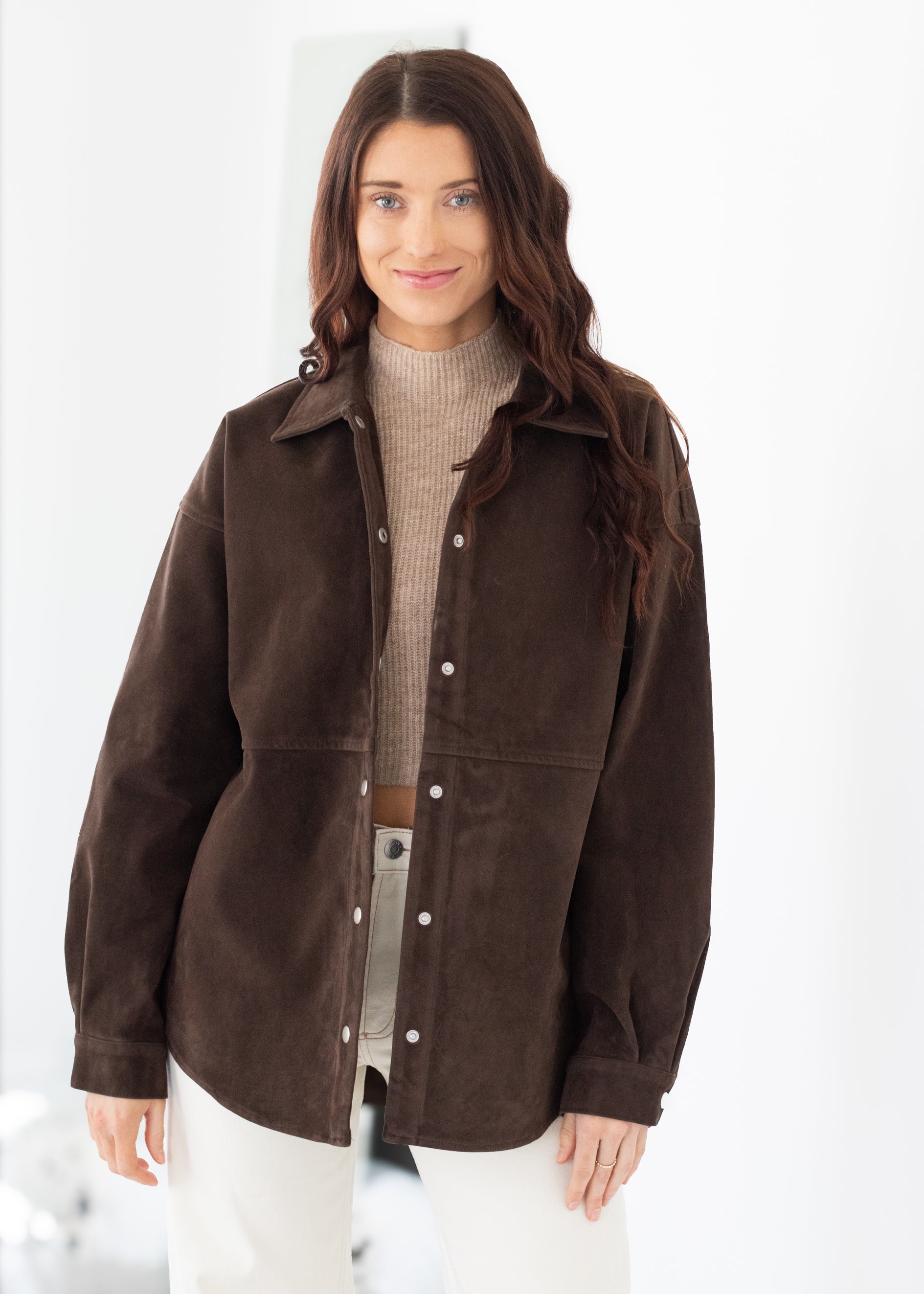 Woman wearing a brown jacket on a white background