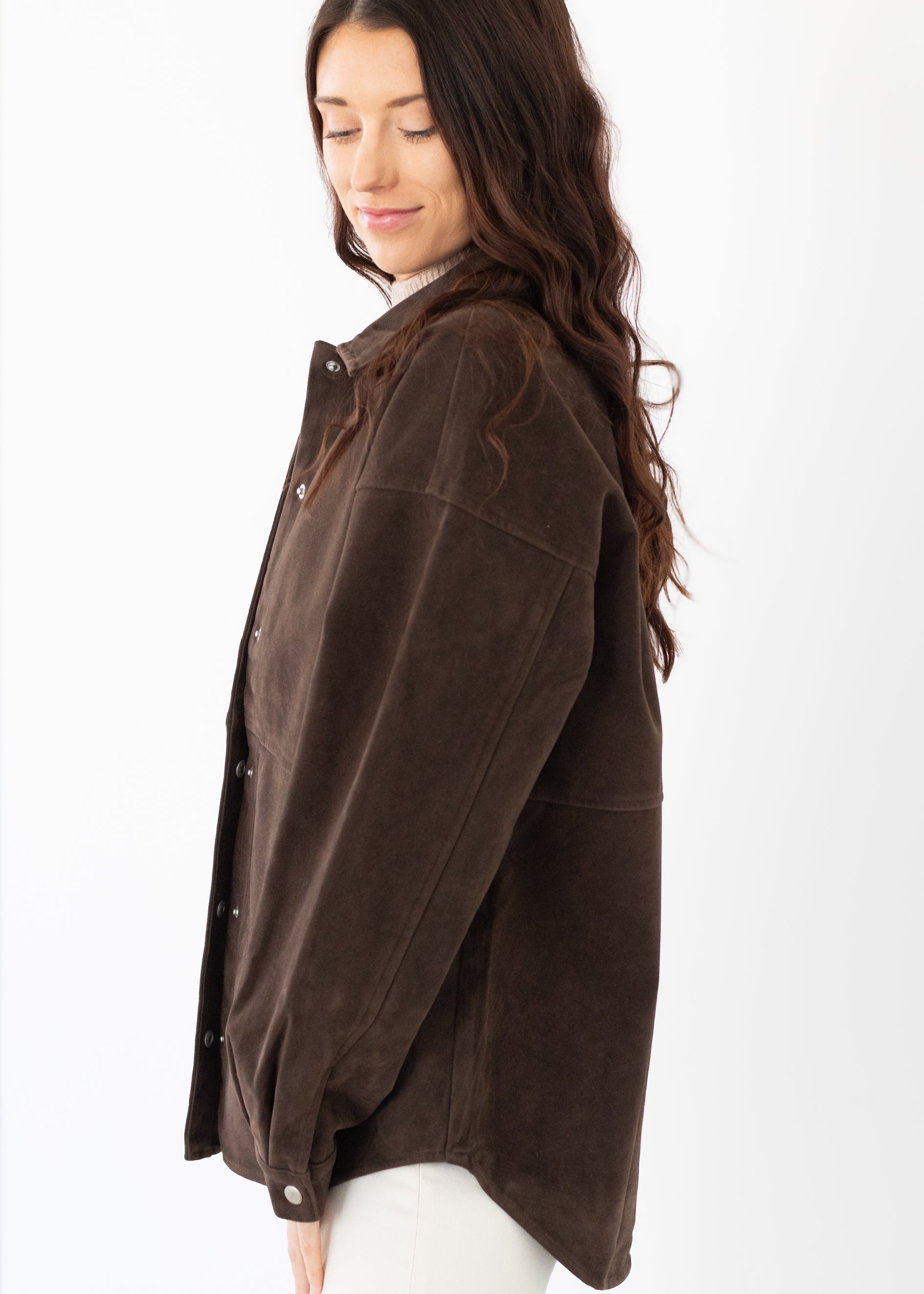 Woman wearing a brown jacket on a white background