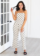 Woman wearing a strapless polka dot matching set indoors.