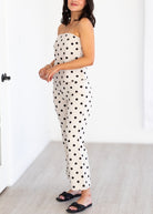 Woman wearing a polka dot set in a minimal indoor setting