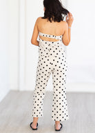 Woman wearing a polka dot matching set with a white background