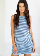 Woman wearing a blue and navy striped set against a plain background