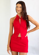 Woman wearing a red set with a white background