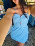 Woman wearing a light blue dress in an indoor setting