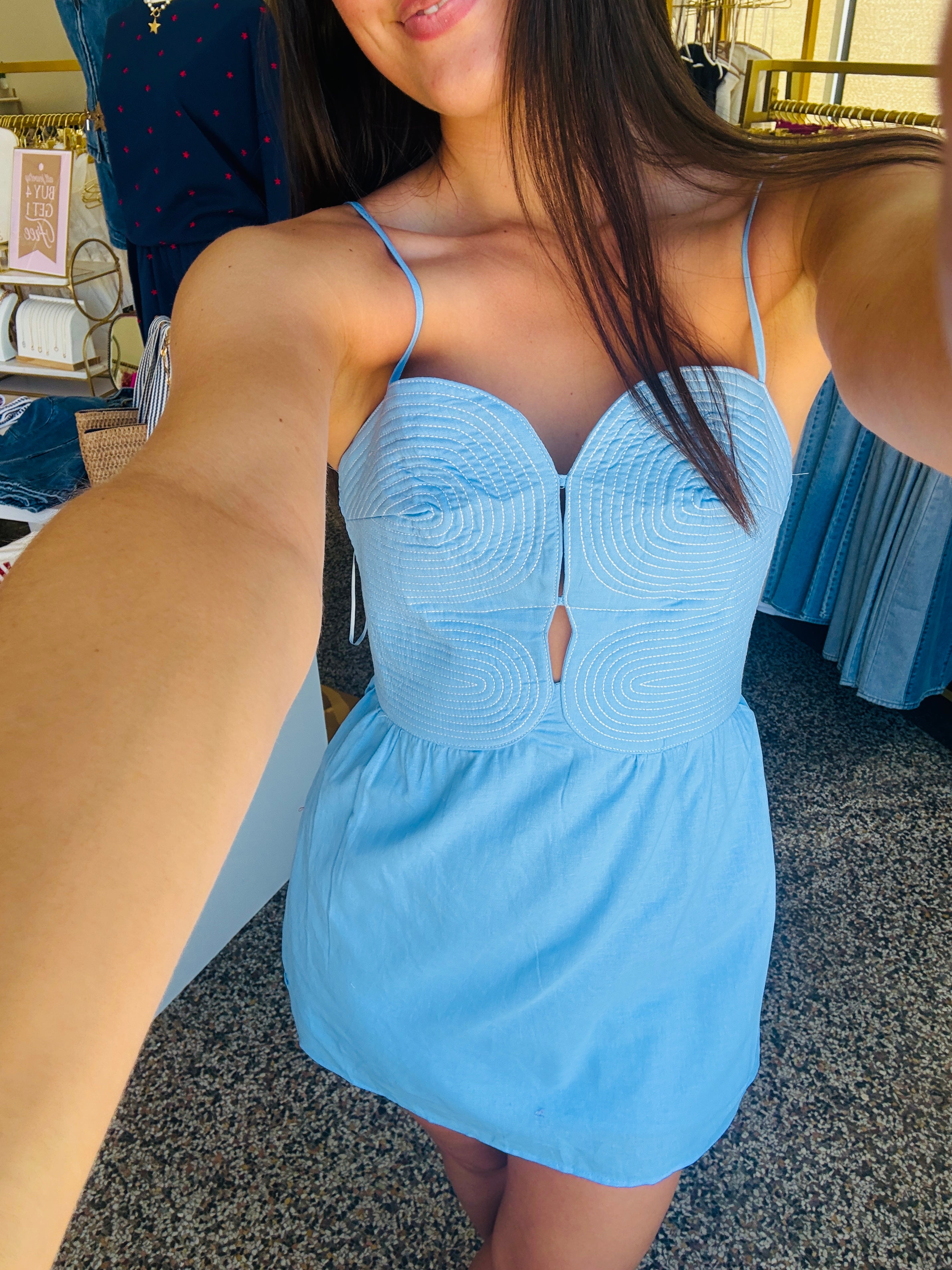 Woman wearing a light blue dress in an indoor setting