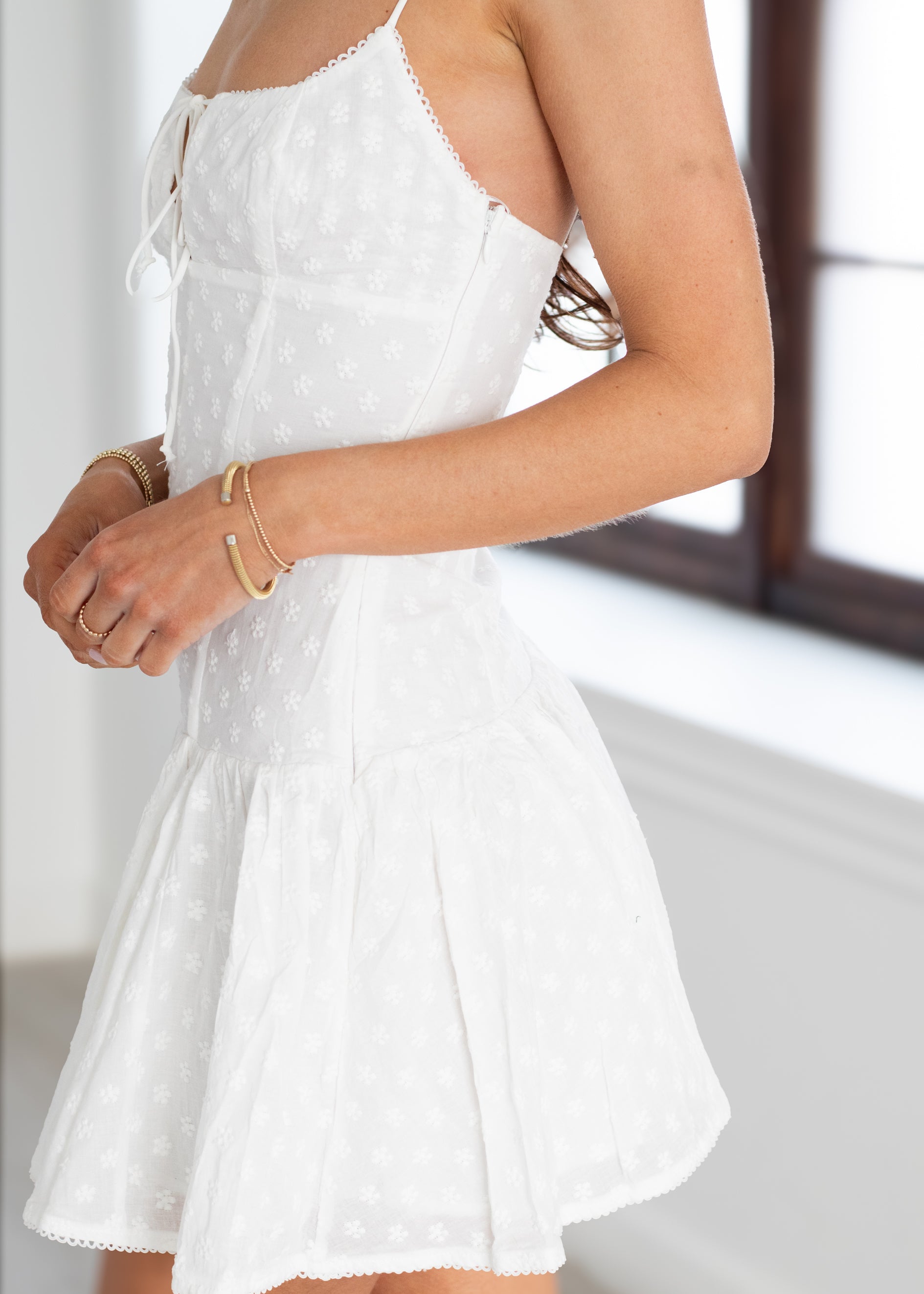White dress with lace details on a blurred background