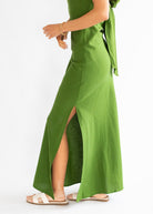 Green dress with a slit on a white background