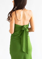 Green dress with a bow detail on a white background