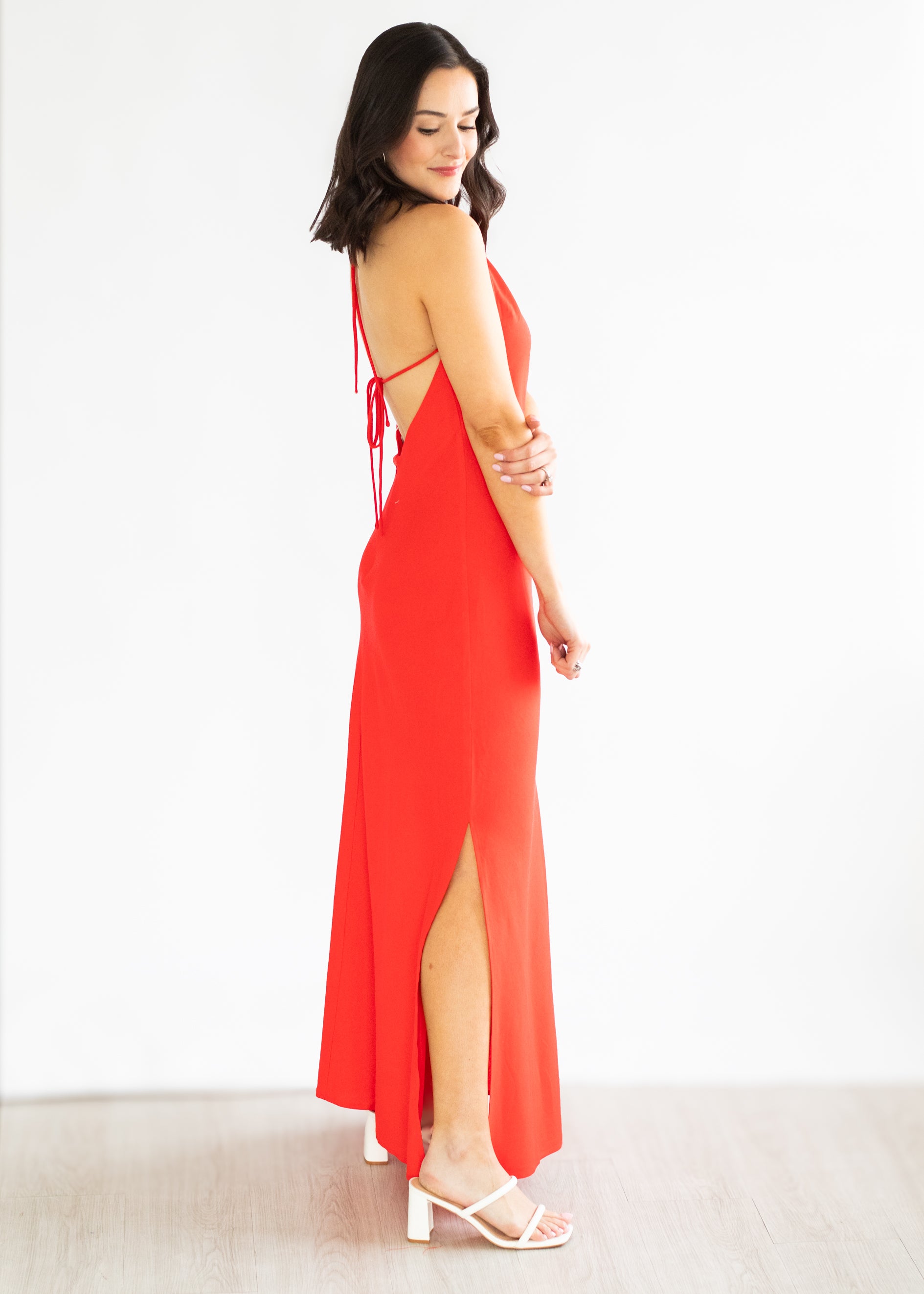 Woman wearing a red dress with a white background