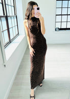 Woman wearing a brown zebra print dress on a white background