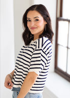 Woman wearing a striped shirt in a bright room