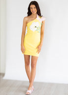 Woman wearing a yellow dress with floral design on a white background