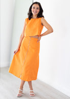 Woman wearing an orange set with a white background