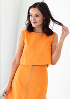Woman wearing an orange set with a white background