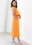 Woman wearing an orange set with a white background