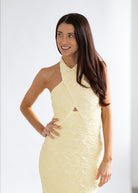 Woman wearing a light yellow dress against a white background