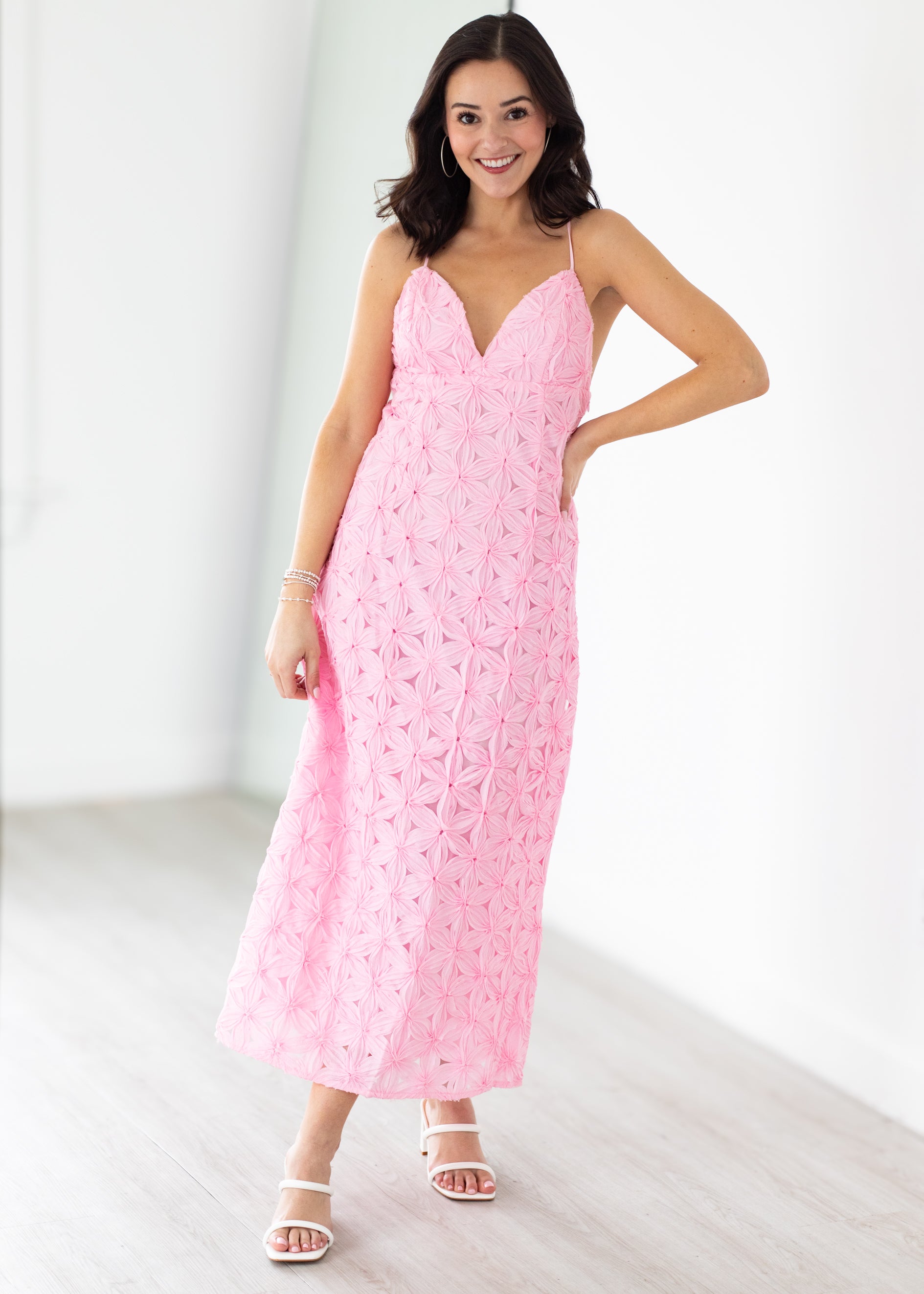 Woman wearing a pink dress with a white background