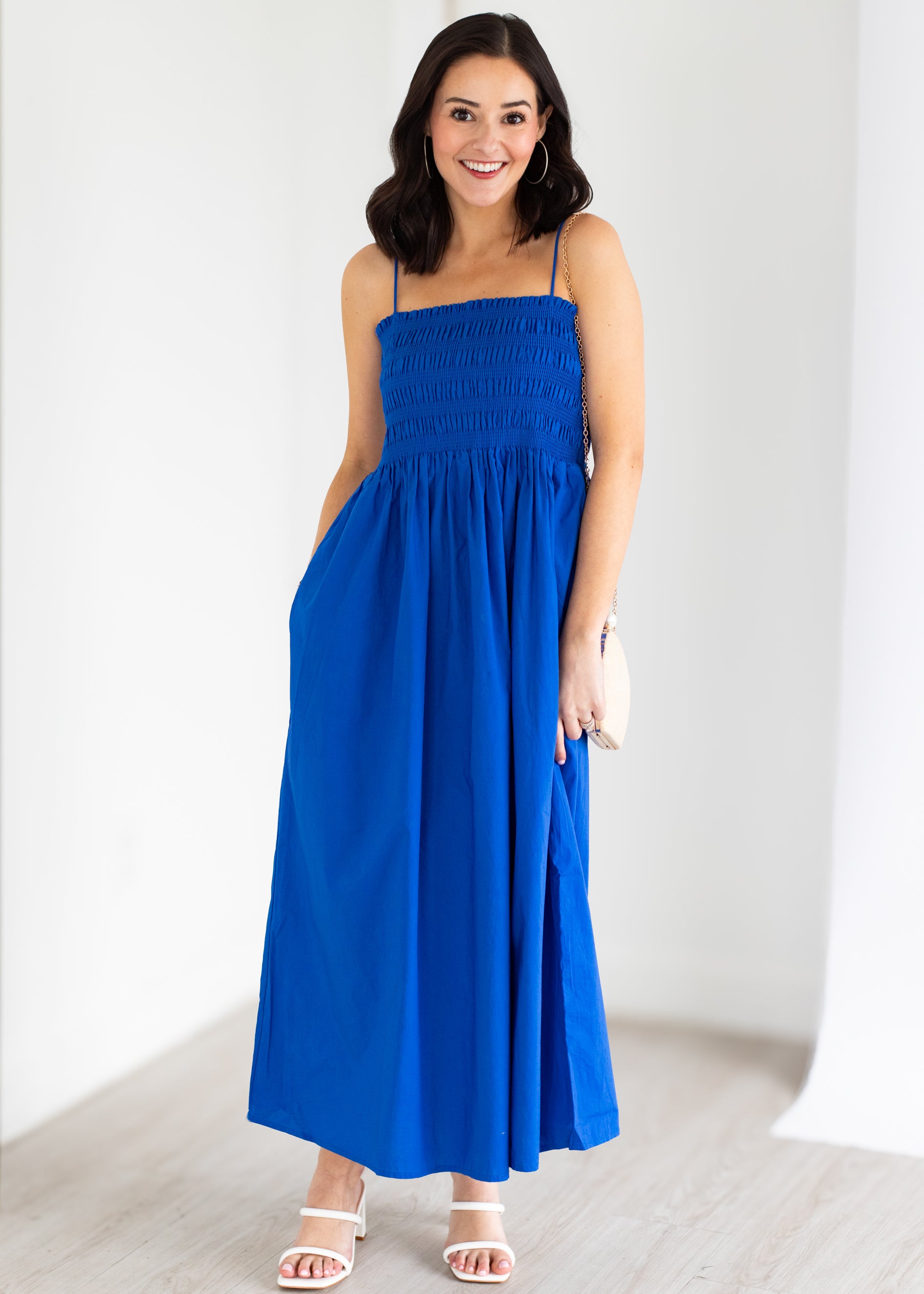 Woman wearing a blue dress against a white background