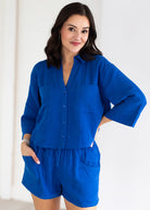 Woman wearing a blue outfit with a white background
