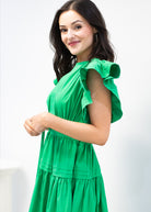 Woman wearing a green dress against a white background