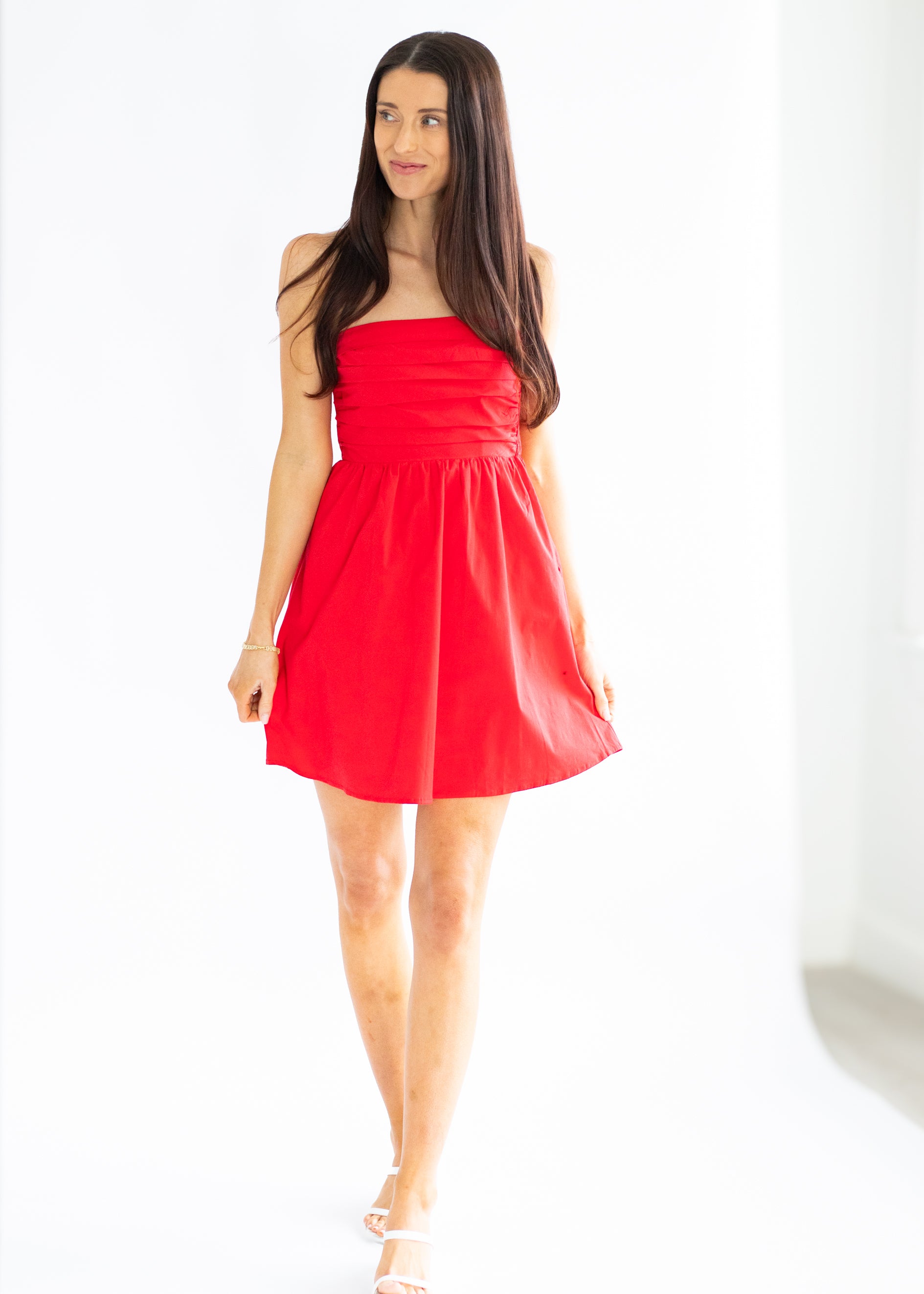 Woman wearing a red dress on a white background