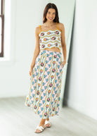 Woman wearing a floral two-piece outfit in a minimal indoor setting
