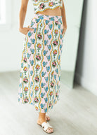 Person wearing a floral dress with a white background