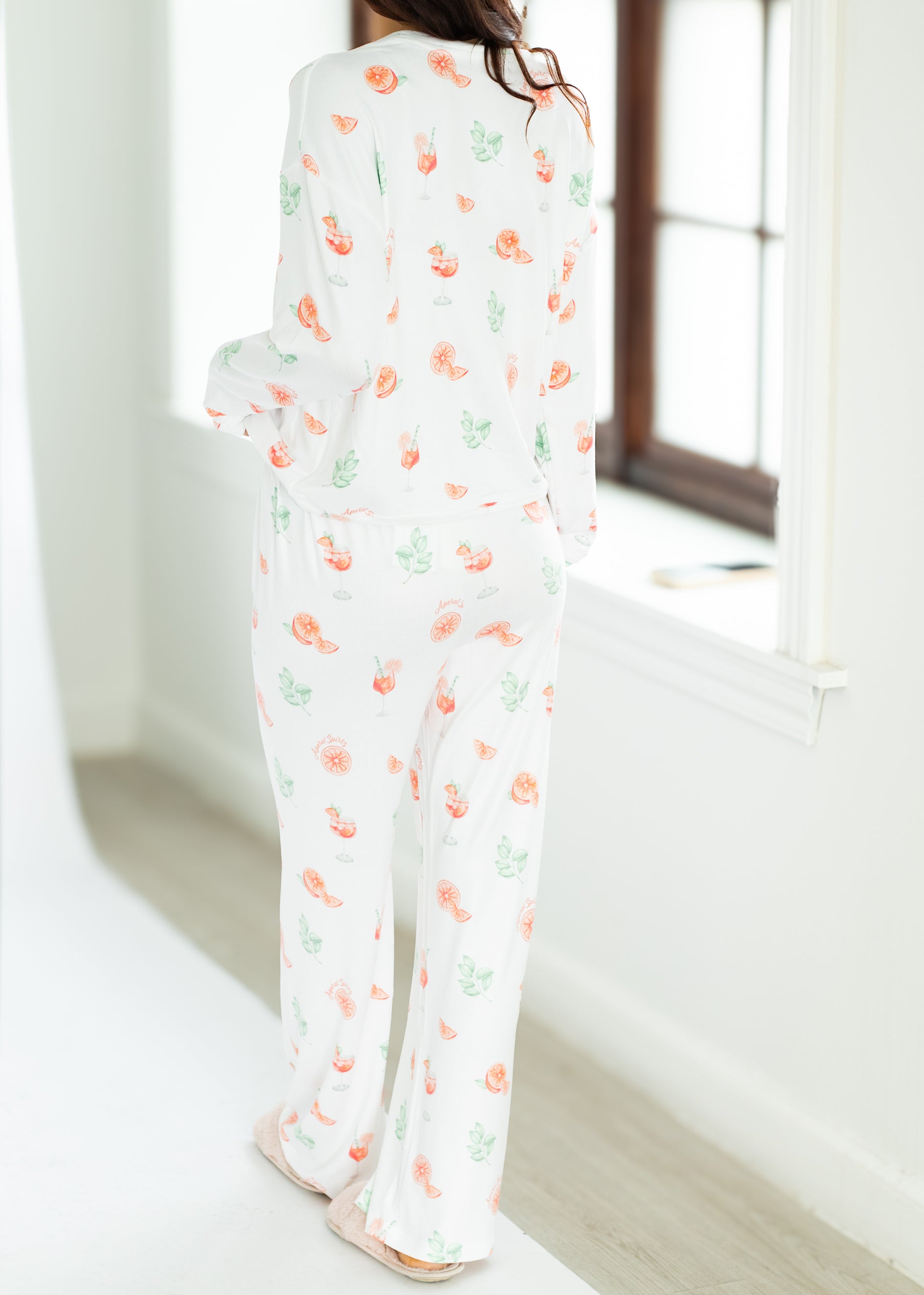 Person wearing a floral pajama set in a bright room.