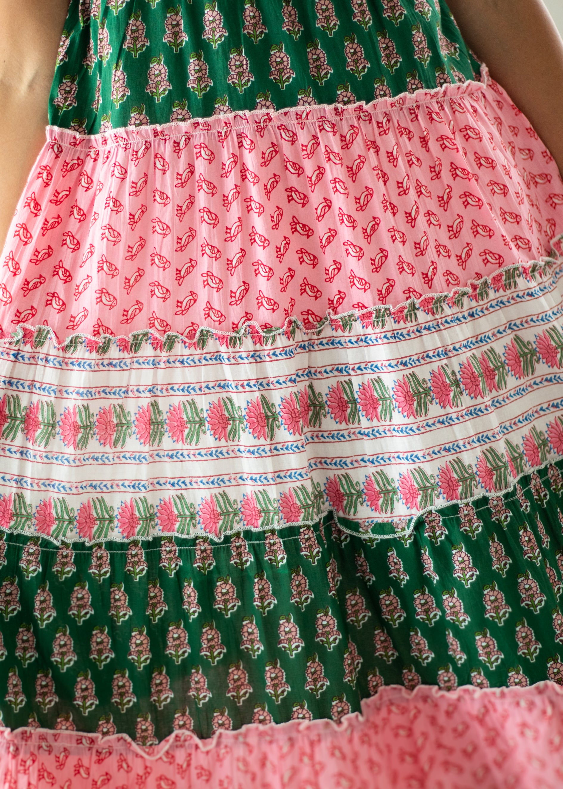 Multicolored patterned fabric with green, pink, and white colors.