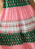 Multicolored patterned fabric with green, pink, and white colors.