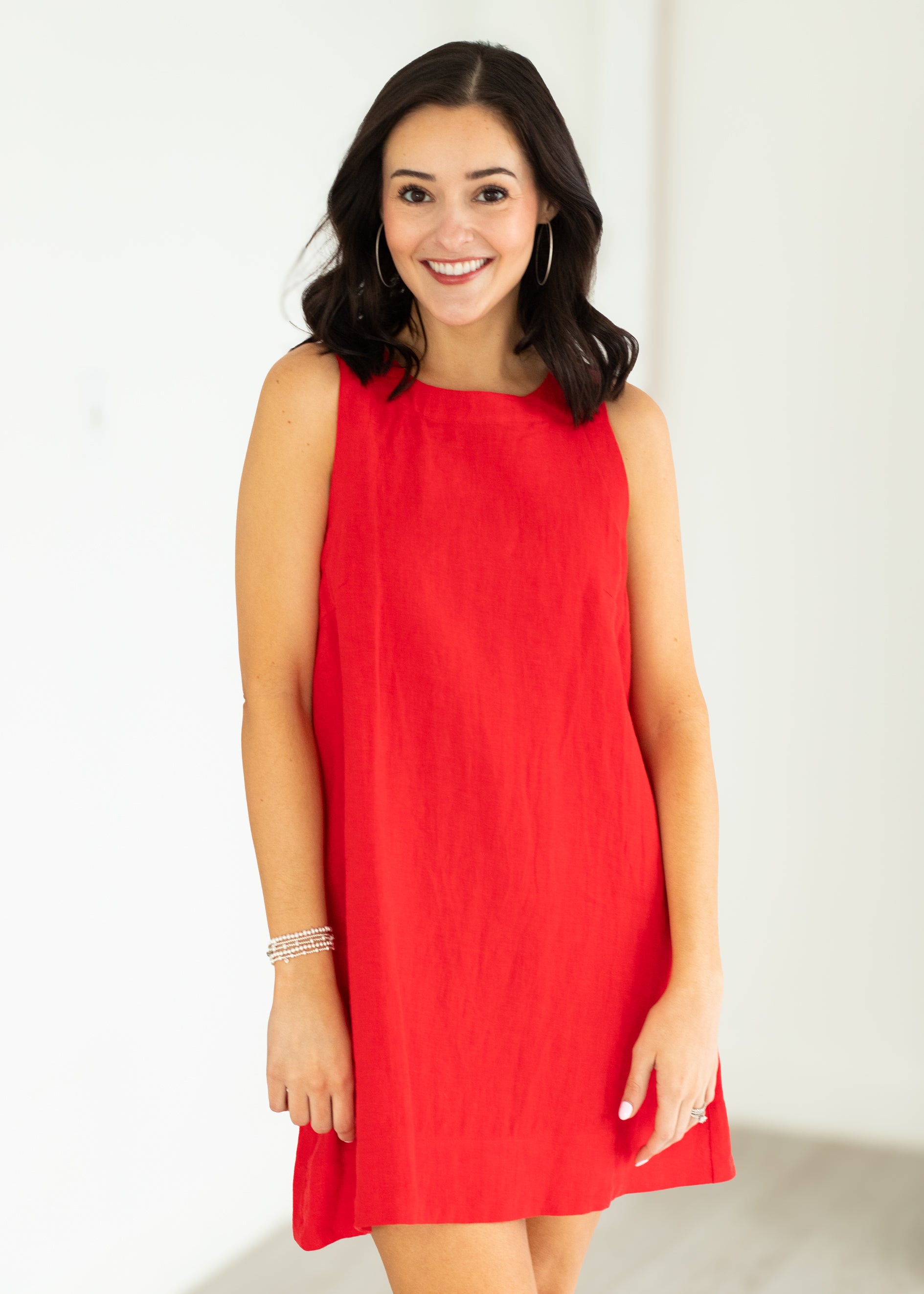Woman wearing a red dress against a white background