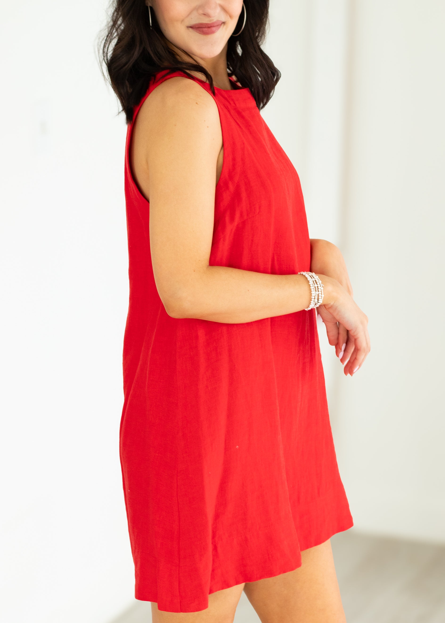 Woman wearing a red dress against a white background