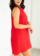 Woman wearing a red dress against a white background