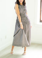 Woman wearing a checkered dress on a white background