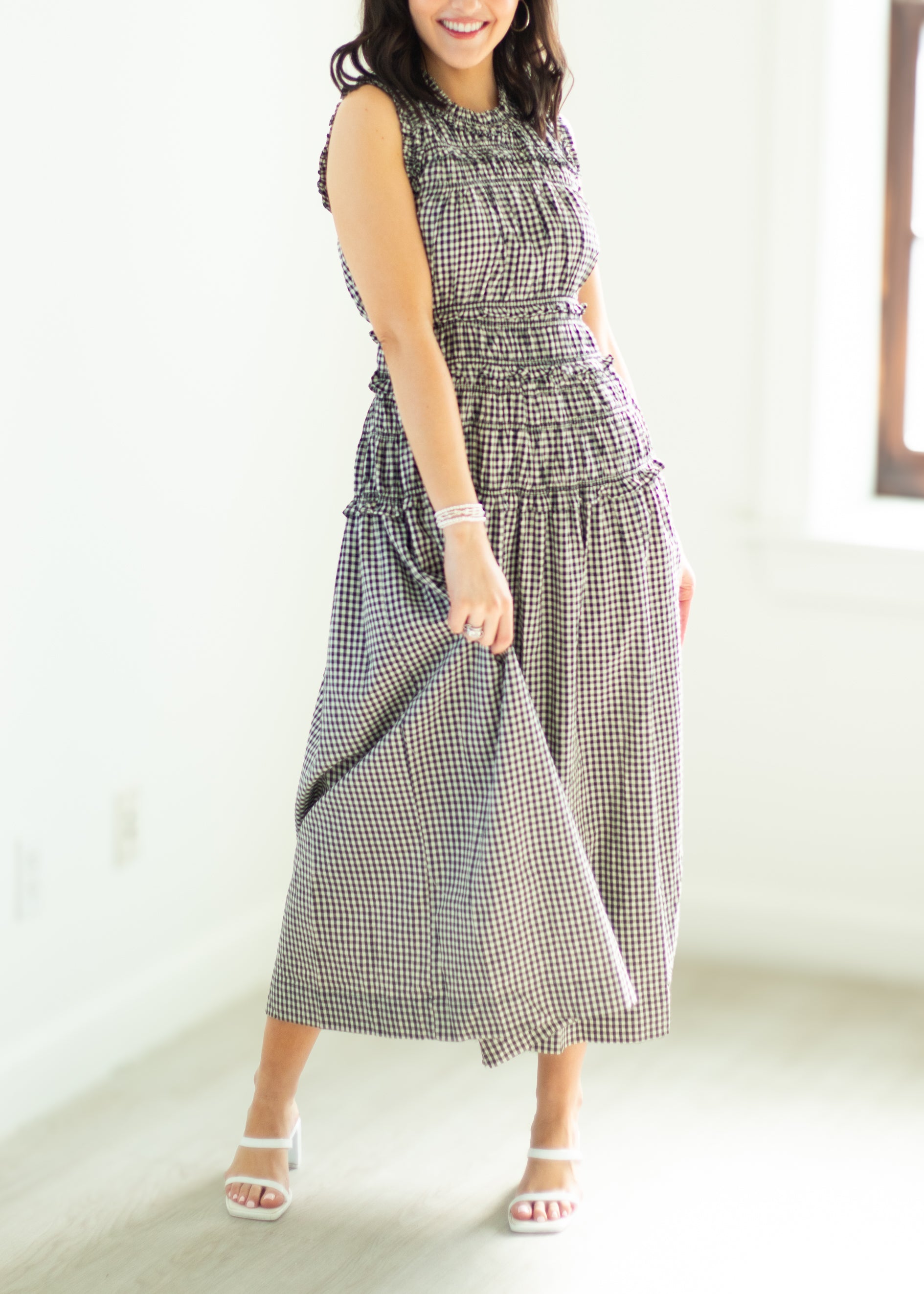 Woman wearing a checkered dress on a white background